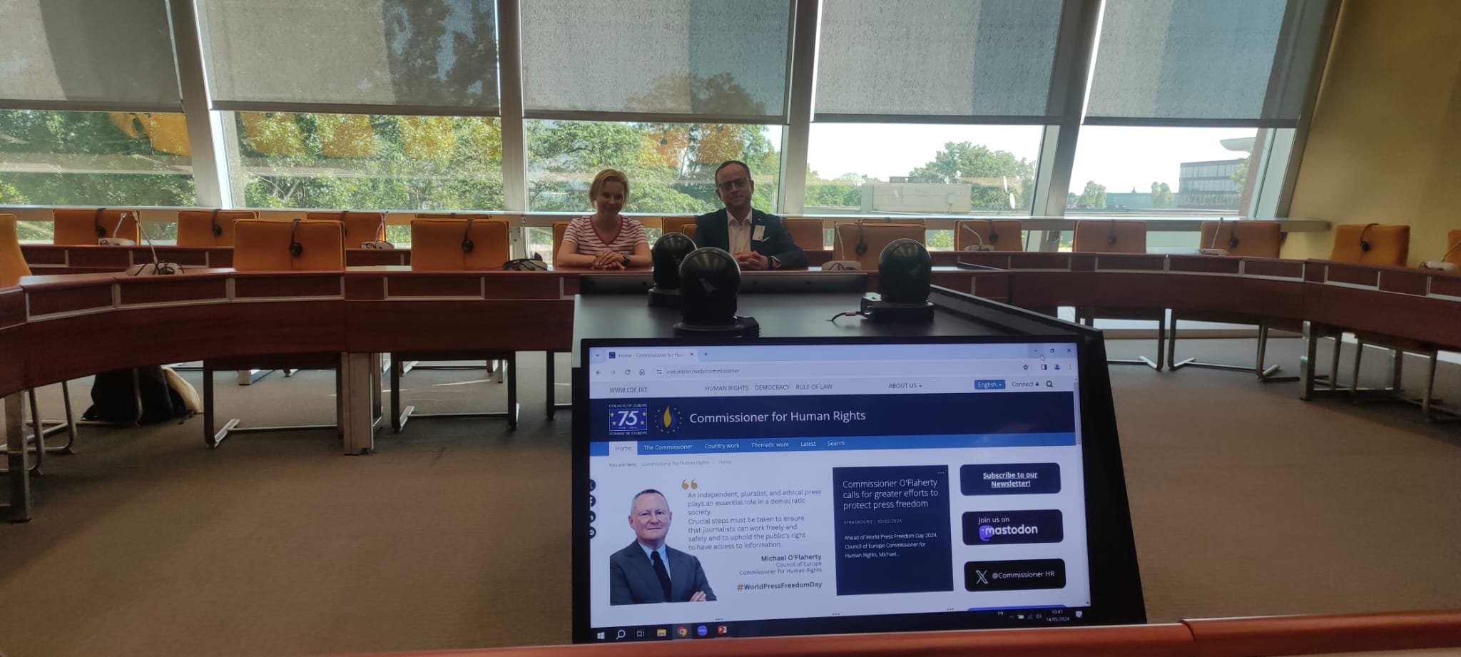 The photo shows two people sitting at a table